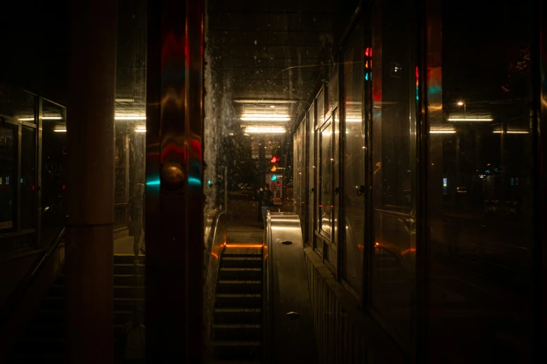 a dark hallway with lots of windows next to an open doorway