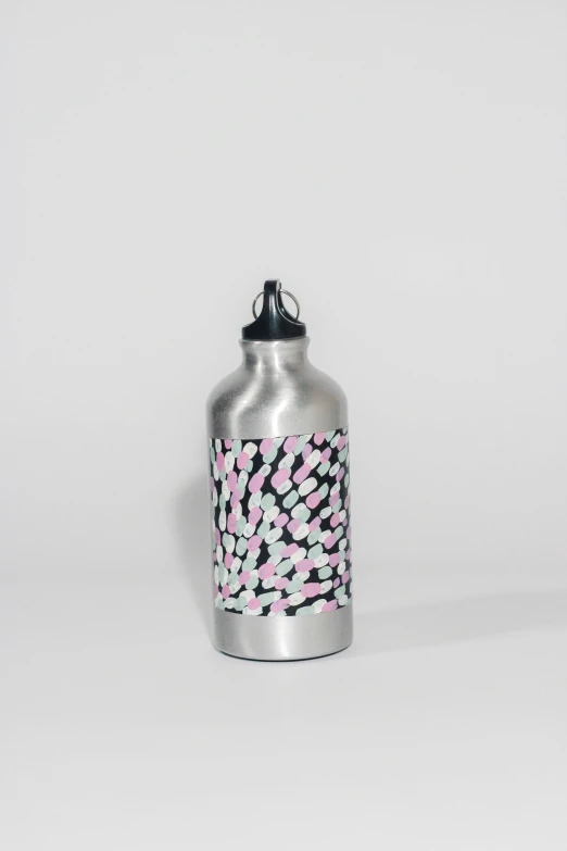 a silver can with pink and black design on it