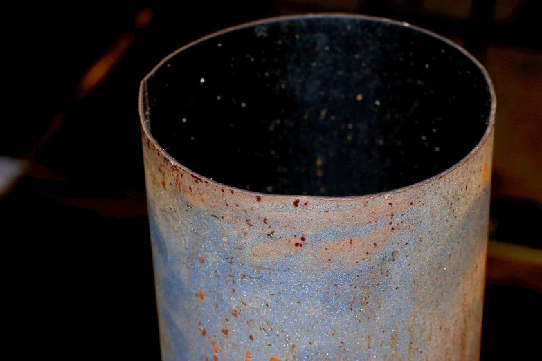 a close up of a metal container with rust on it