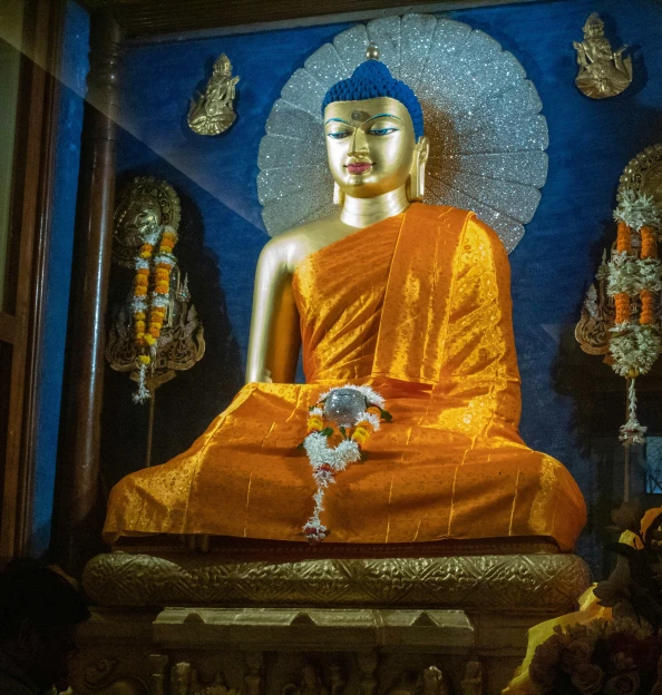 a buddha statue sits in an ornate space