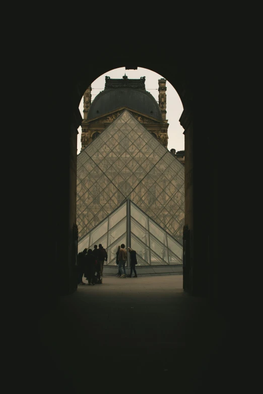 view of pyramid with small group in courtyard looking out to sea