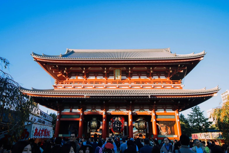 a pagoda in the middle of a city with people walking around