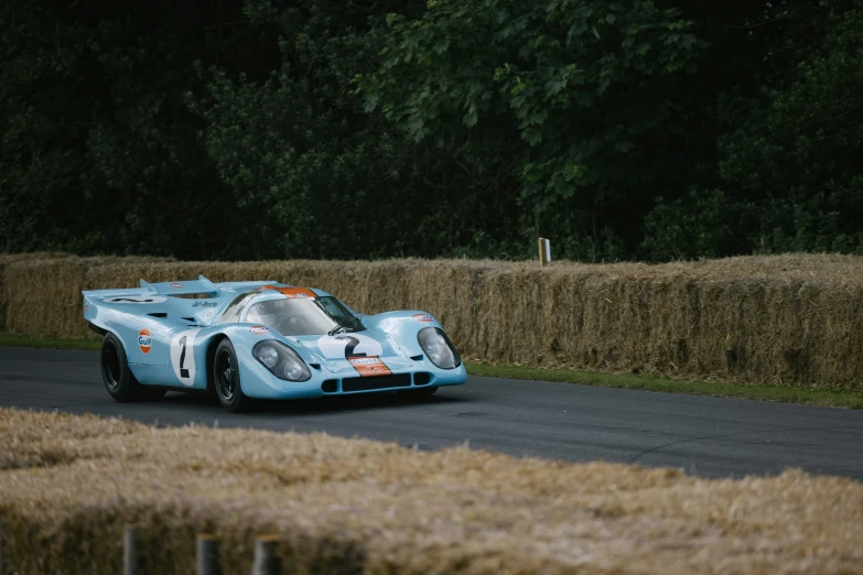 an old race car is coming down the track