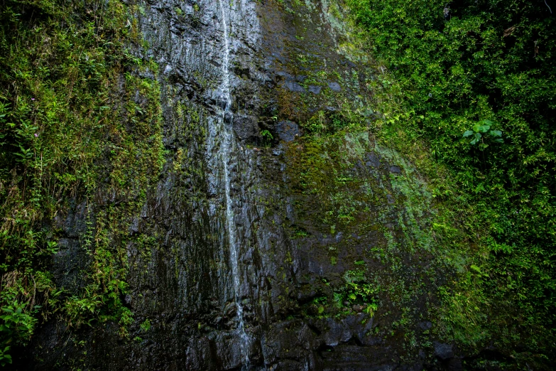 a man riding a surf board on top of a waterfall