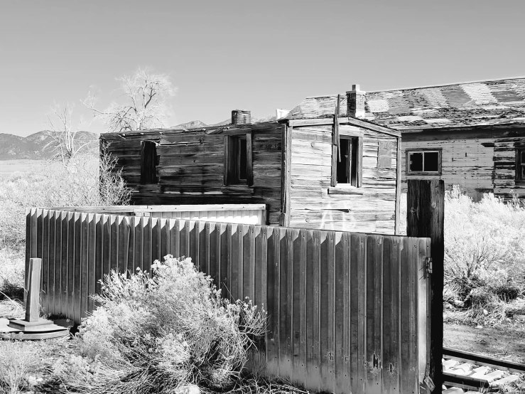 the remains of an old shack near a field