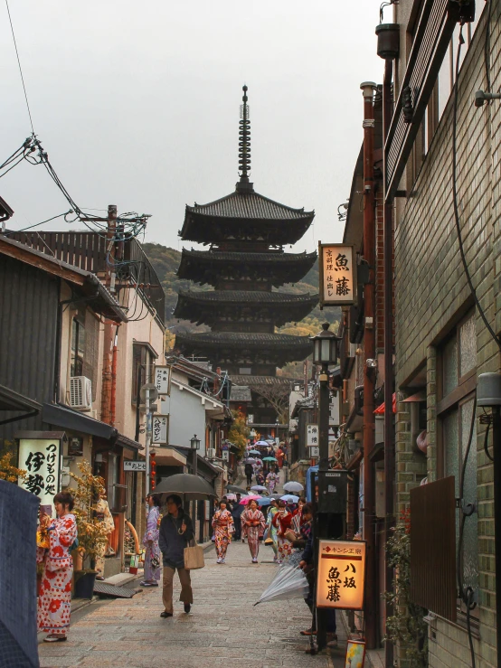 an old city street lined with shops and a building