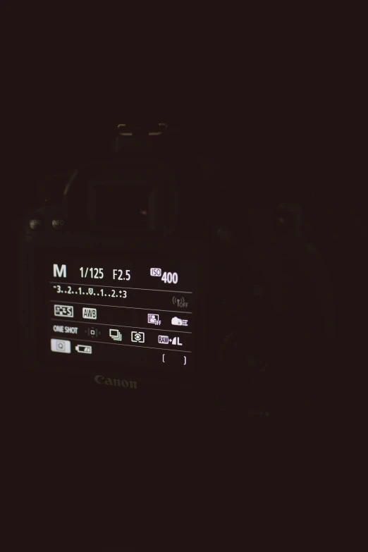 an analog camera sitting in the dark with its light on