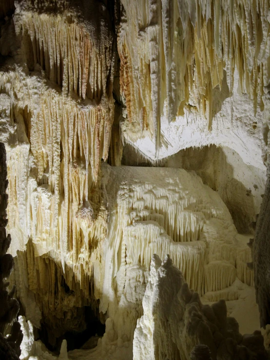 the walls of an underground cave are covered in ice