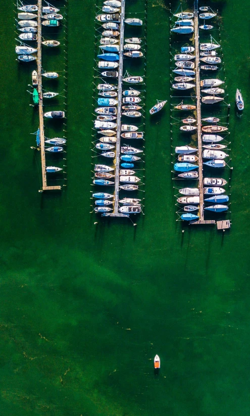 small boats parked in the water on an elevated dock