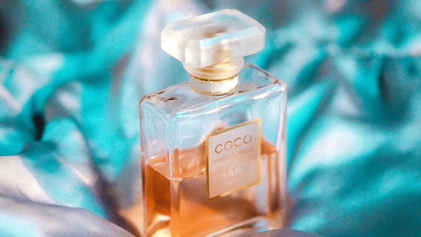 someone holding onto a bottle with the name coco in it