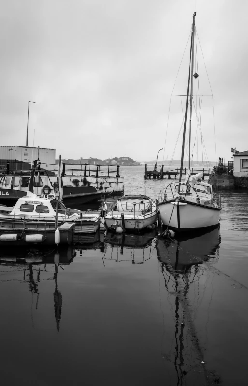 there is a small sail boat at a dock