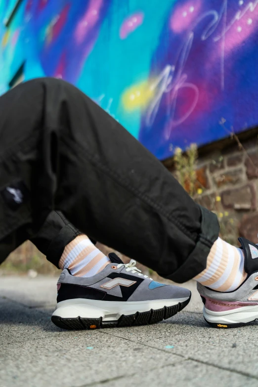a man's foot resting on a bench with some graffiti in the background