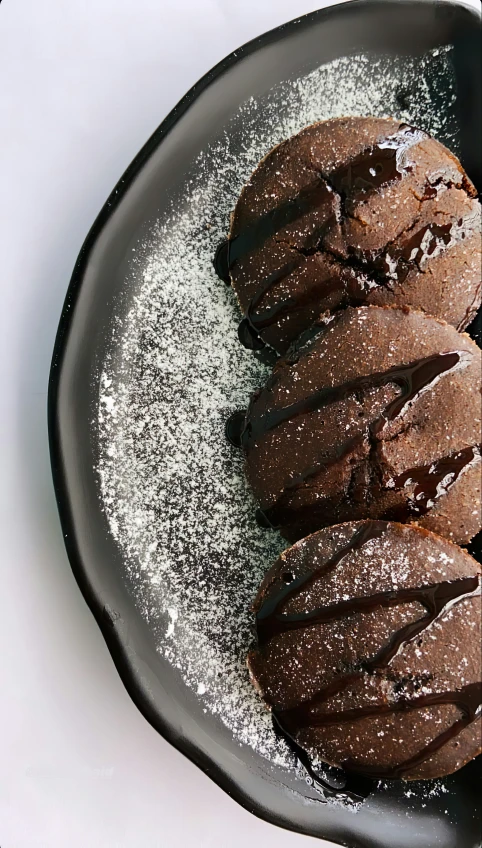 chocolate ice cream and sugar in an ice cream filled black plate