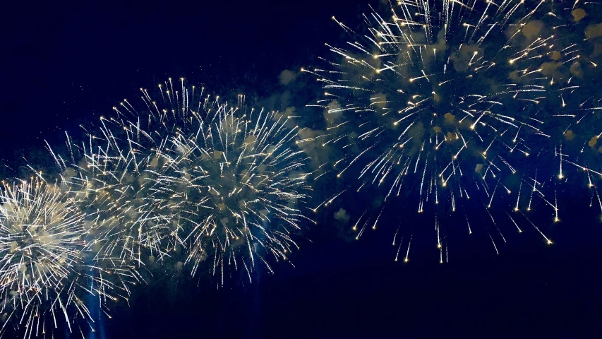 several fireworks with bright white lights and black sky