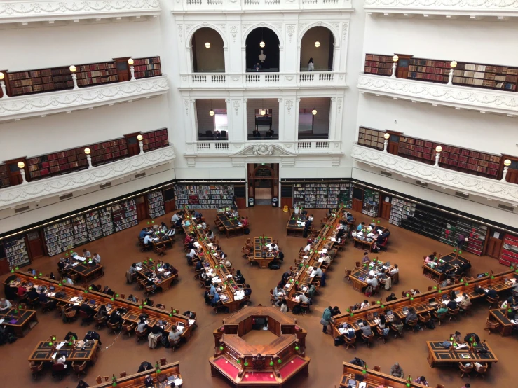 a large room with many people sitting in them