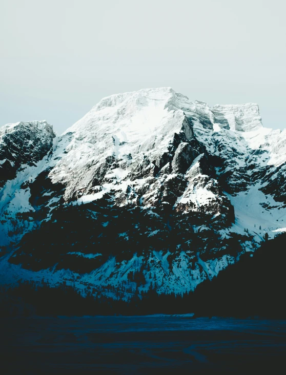 snow covered mountain tops in an empty blue sky