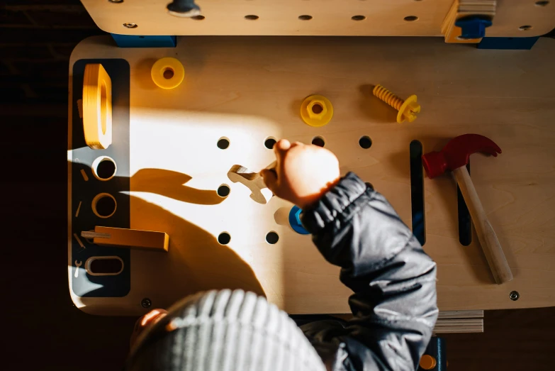 a child playing with different tools like pegs