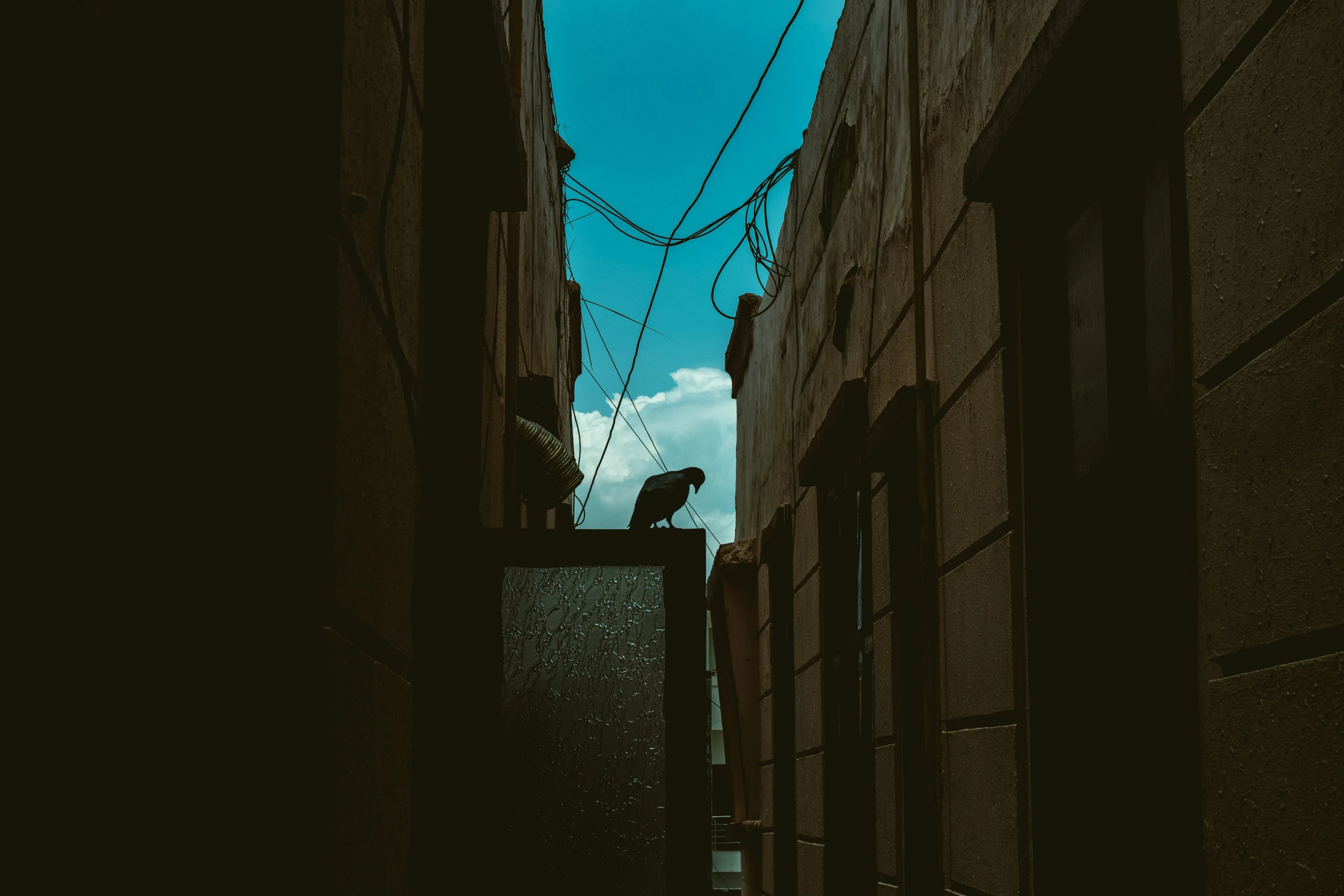 a person walking down a narrow street with buildings