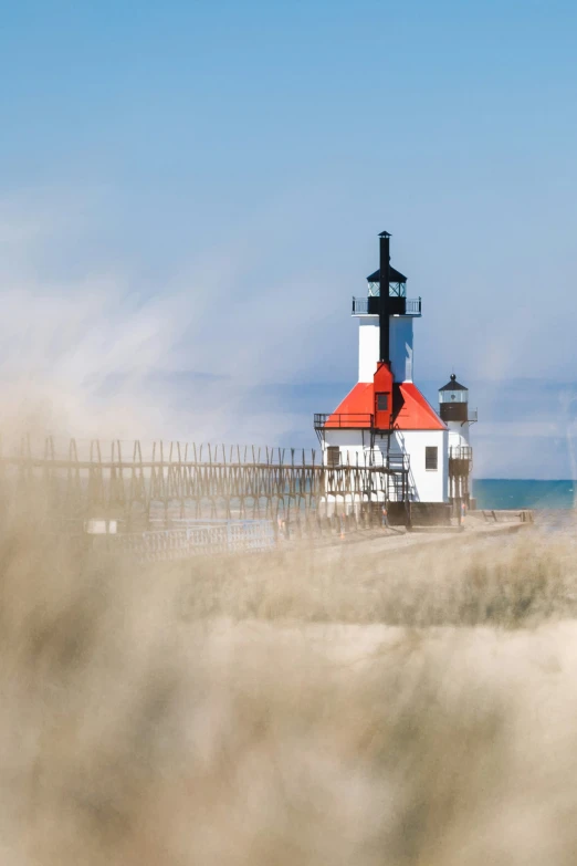 there is a lighthouse on a sandy beach