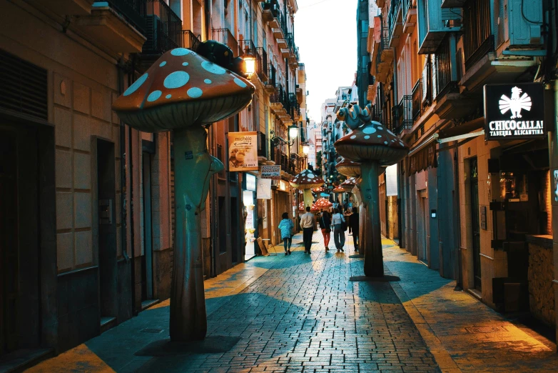 people walking on a street at night with tall buildings