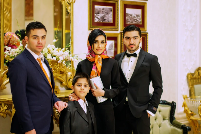 a woman and two men are dressed up for the occasion