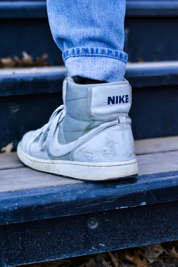 a pair of jeans and sneakers with the word nike written on the bottom