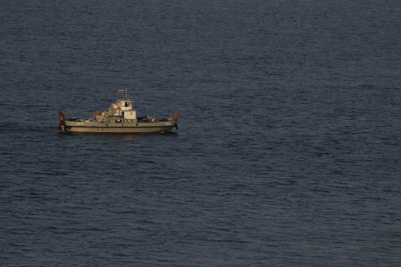 the boat is floating in the middle of a large body of water