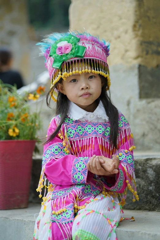 a  sitting in the street with flower pot