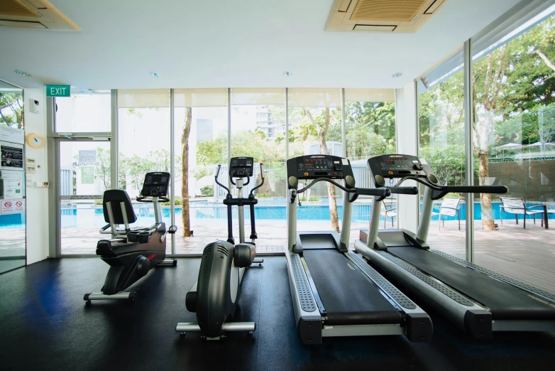 an exercise room in a el with a swimming pool