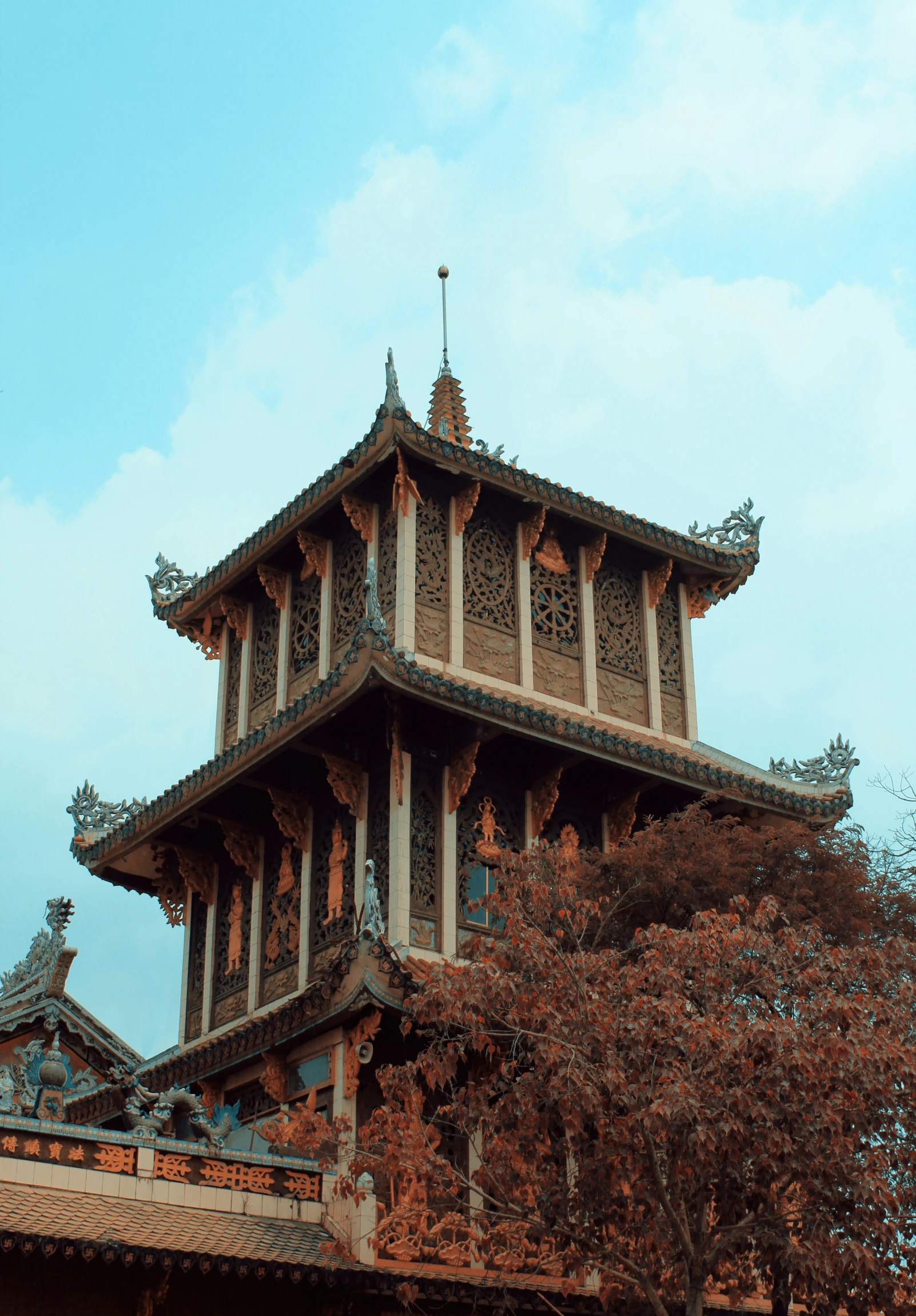 an oriental - inspired building sits upon the sky on a sunny day