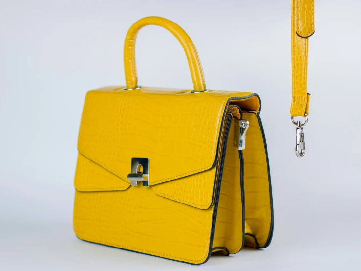 an empty yellow handbag sitting next to a purse