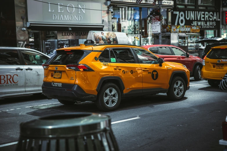 a bright yellow jeep is driving down the street