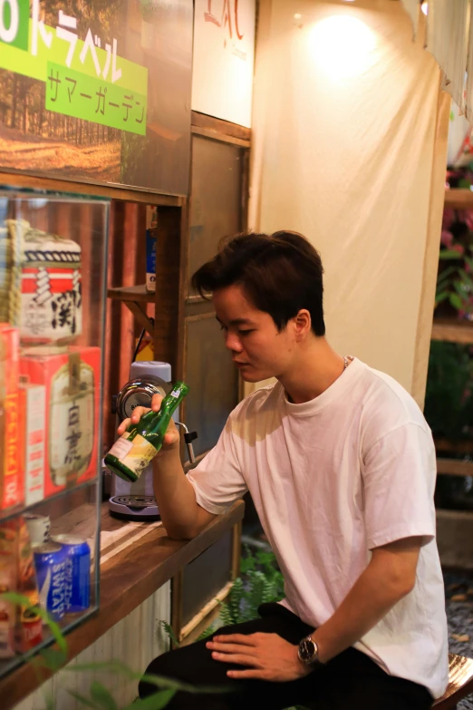 man putting cans in a vending machine in japan