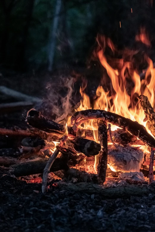 a big bonfire blazing outside at night