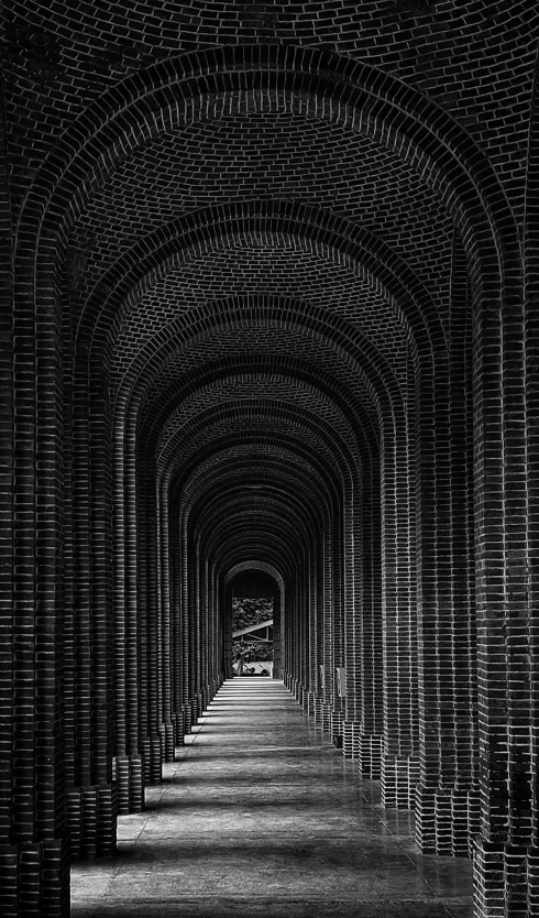 a tunnel filled with lots of bricks in black and white