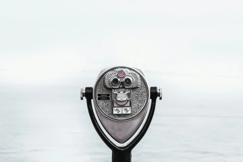 a coin operated money meter sitting on the side of a pole