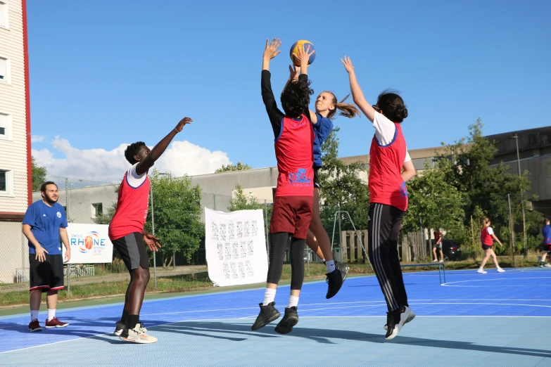 a group of children playing a game of basketball