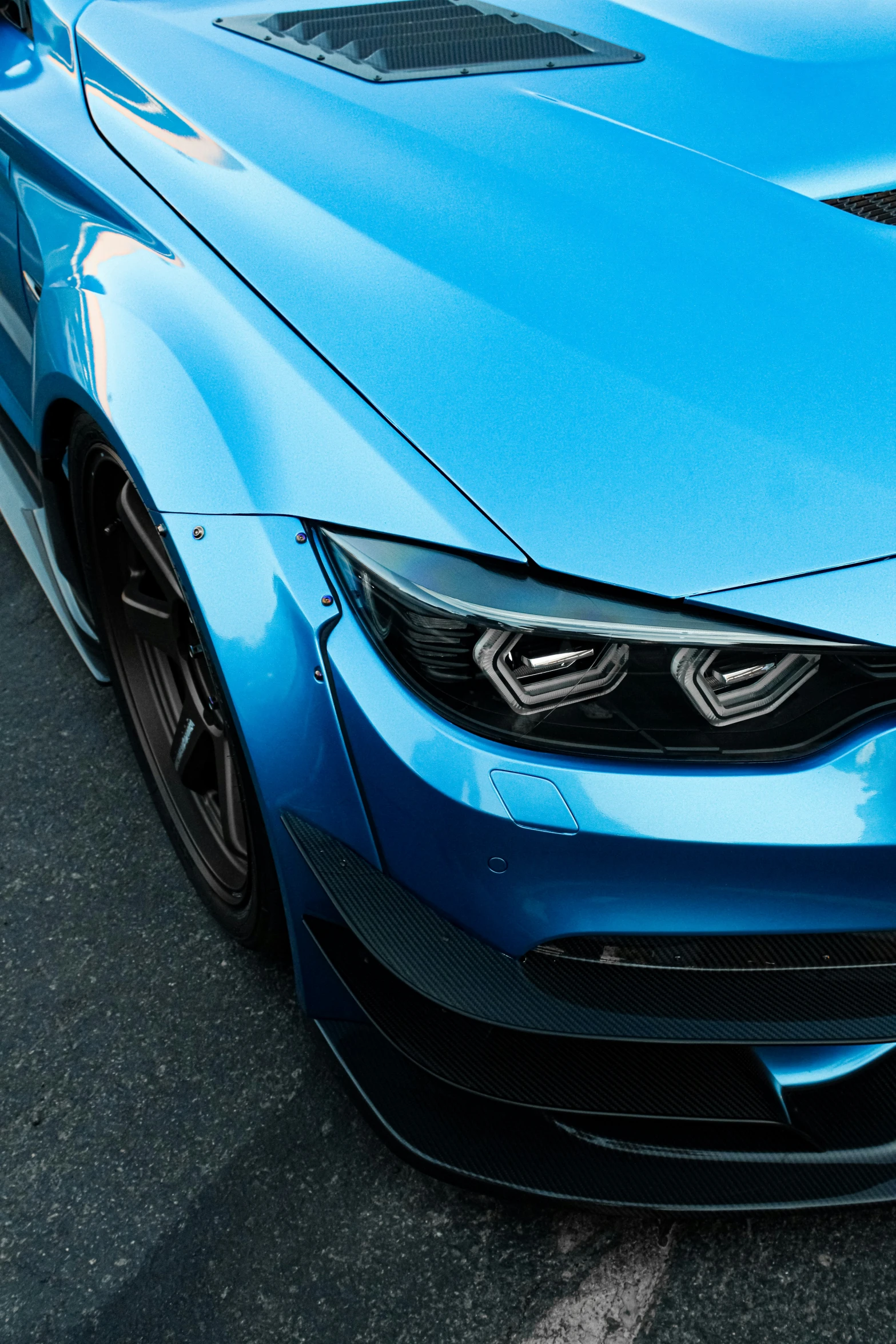 a blue bmw vehicle with its hood hood up