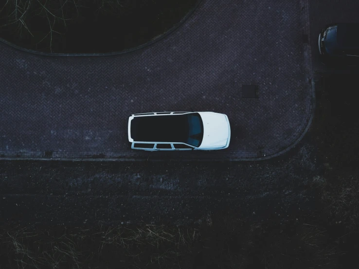 an aerial view of a white and black car