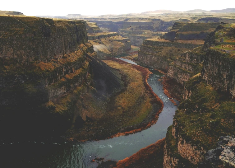 a landscape po with a stream running between two hills