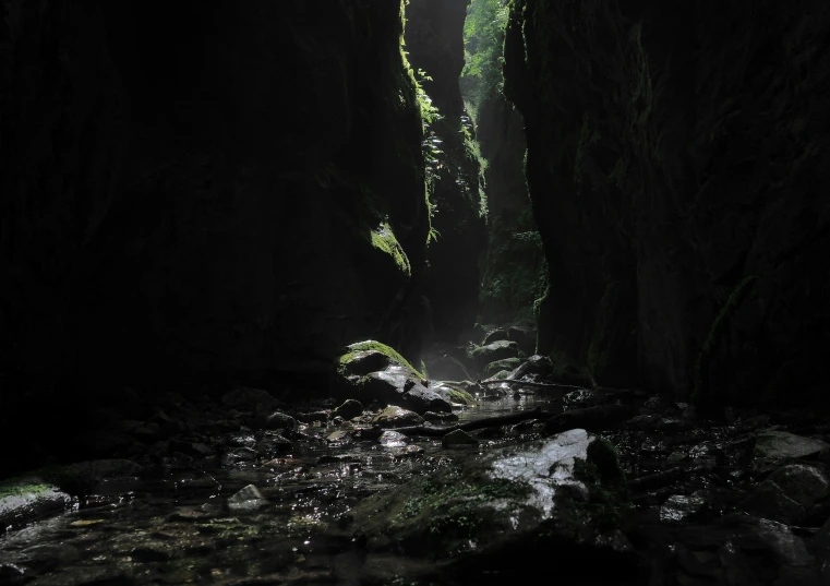 a waterfall in a cave with a long light flowing