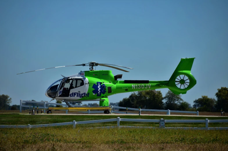 a large green helicopter that is parked by itself