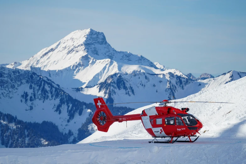 a helicopter that is parked on a snow covered slope