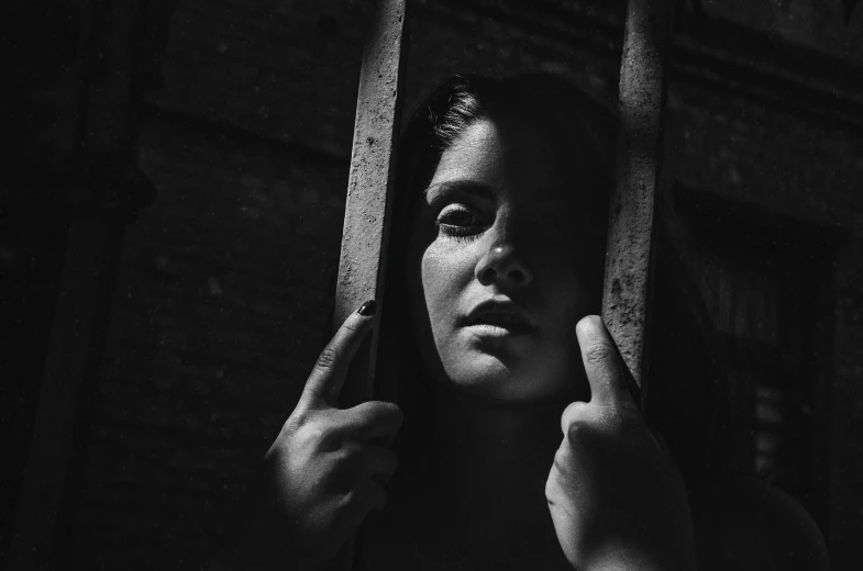 a woman holding a pair of scissors next to her face