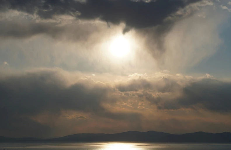 a view of a cloudy sky and some sun shining