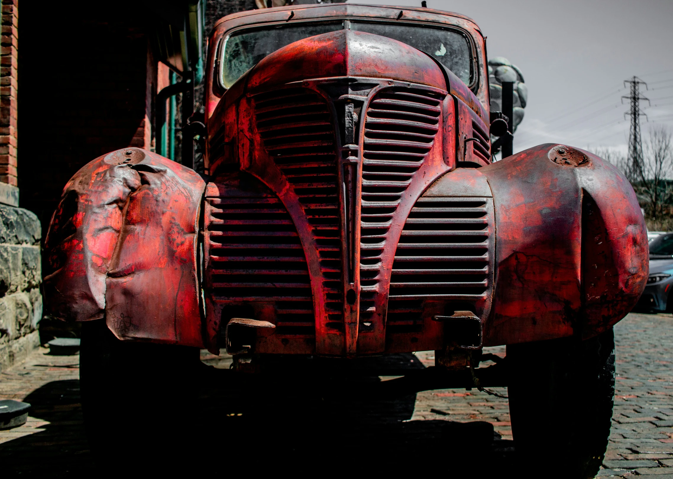 an old red fire truck parked in front of a brick building