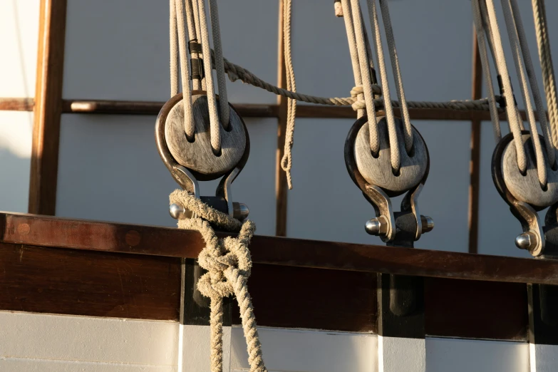 several ropes and hooks that have been hooked to a wall