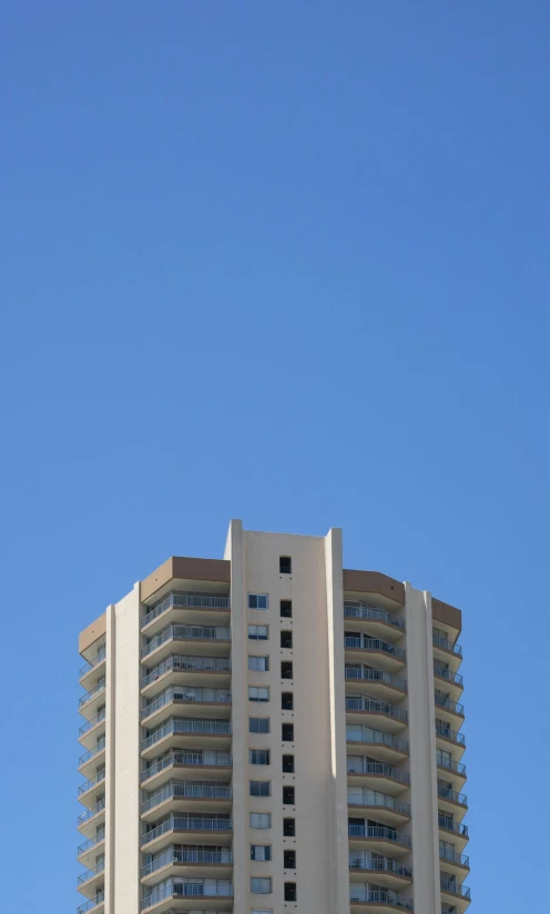 a large tall white building with a sky background