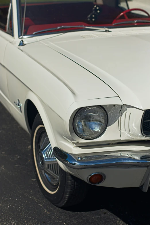 a classic convertible parked outside on a parking lot