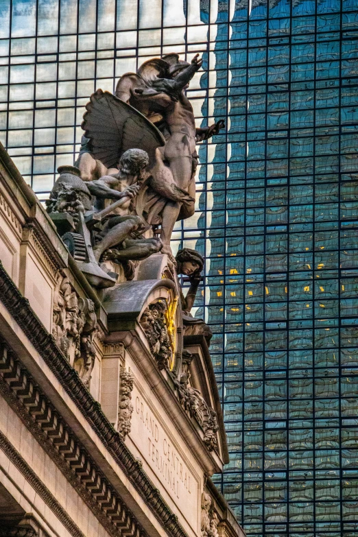 the building with a very tall sculpture on it has very large windows